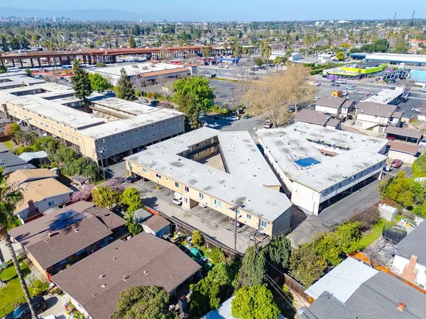 an aerial view of a residential apartment building with swimming pool and ocean view