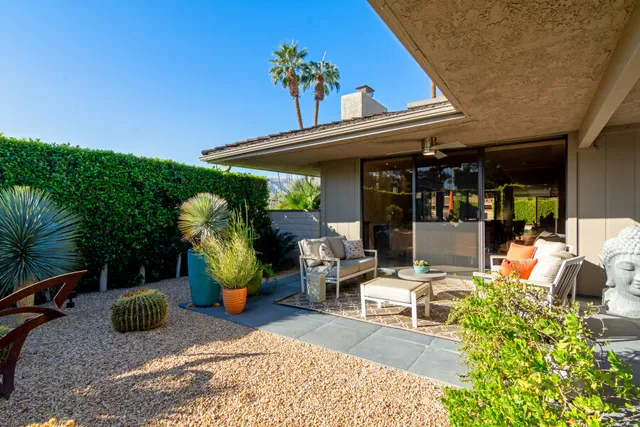 a wooden bench sitting in front of a building