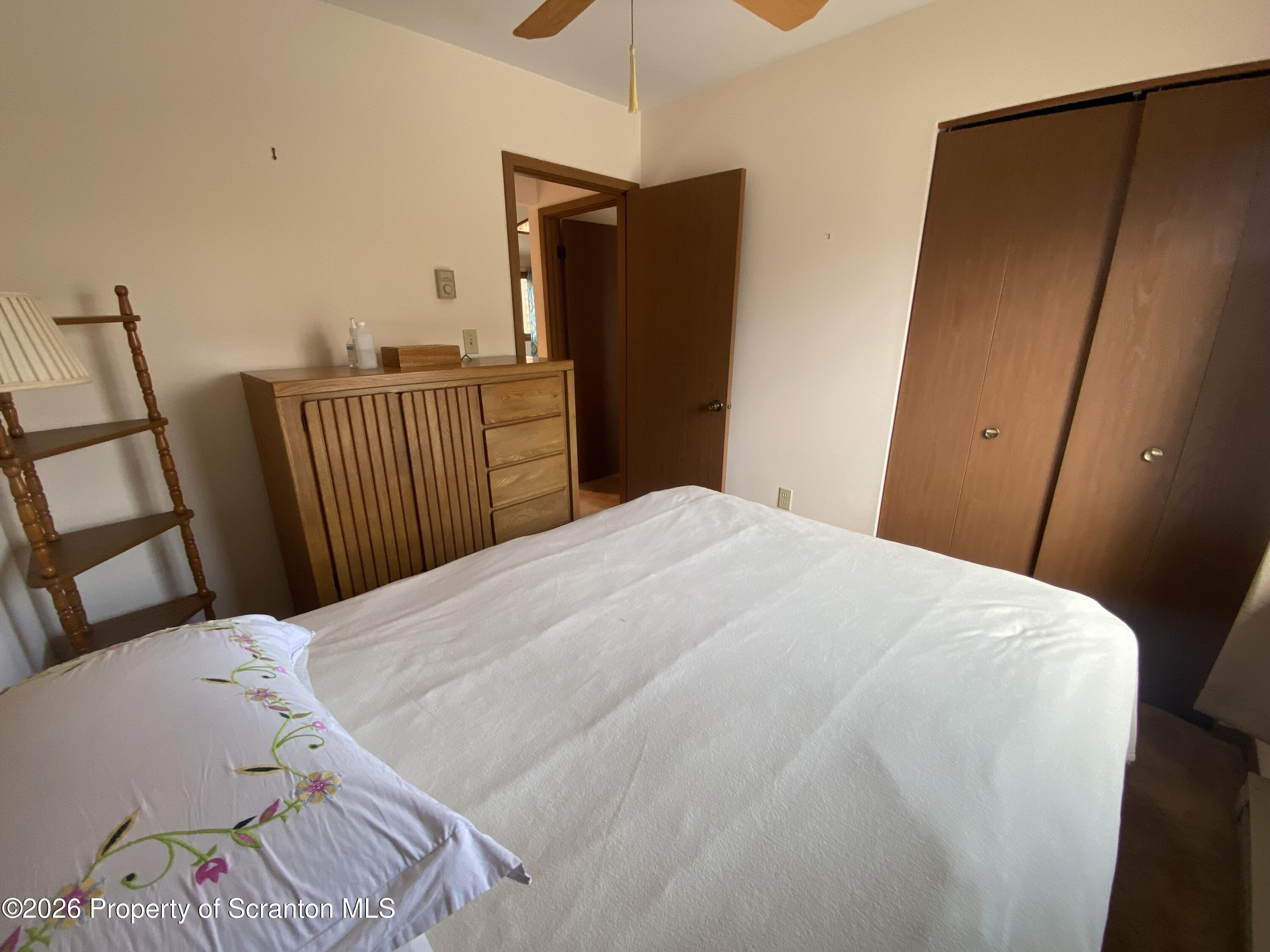 211 Falls Circle Bushkill, PA 18324 - Photo 16 of 28 a bedroom with a bed and wooden floor