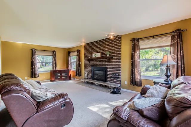a bedroom with a bed couch and a large window