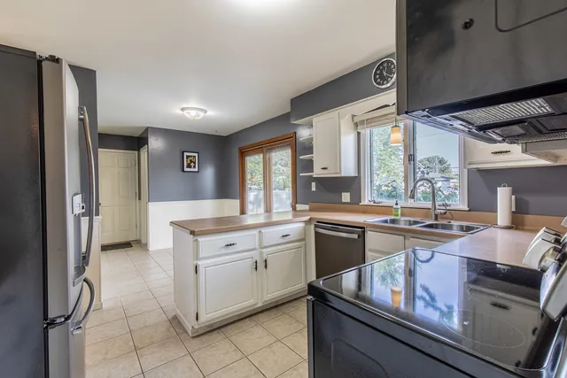 a kitchen with a sink stove and refrigerator