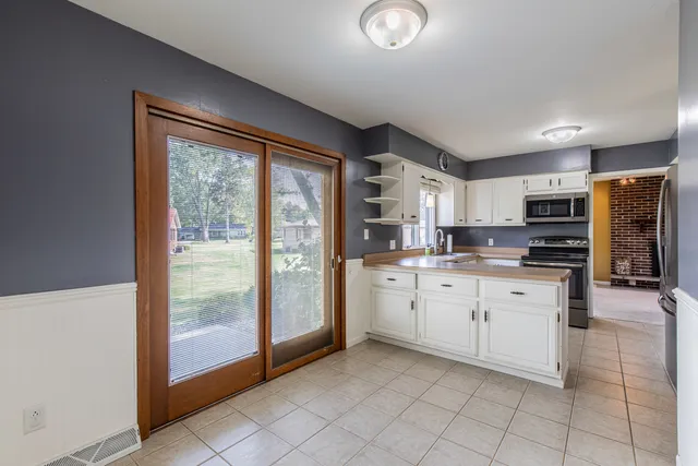 a kitchen with appliances cabinets and a sink