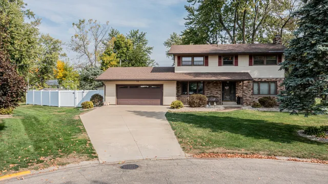a front view of a house with a yard garage and outdoor seating