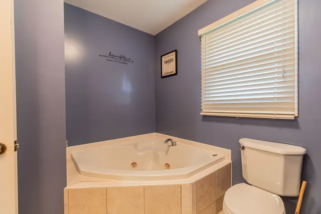 a white bath tub sitting next to a white toilet