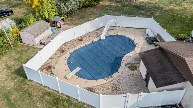 swimming pool view with a sitting space
