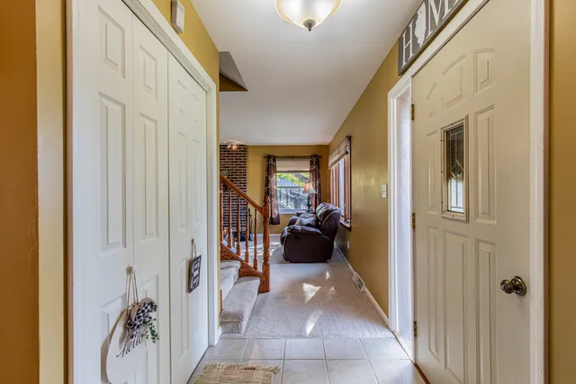 a view of a hallway and a livingroom with furniture