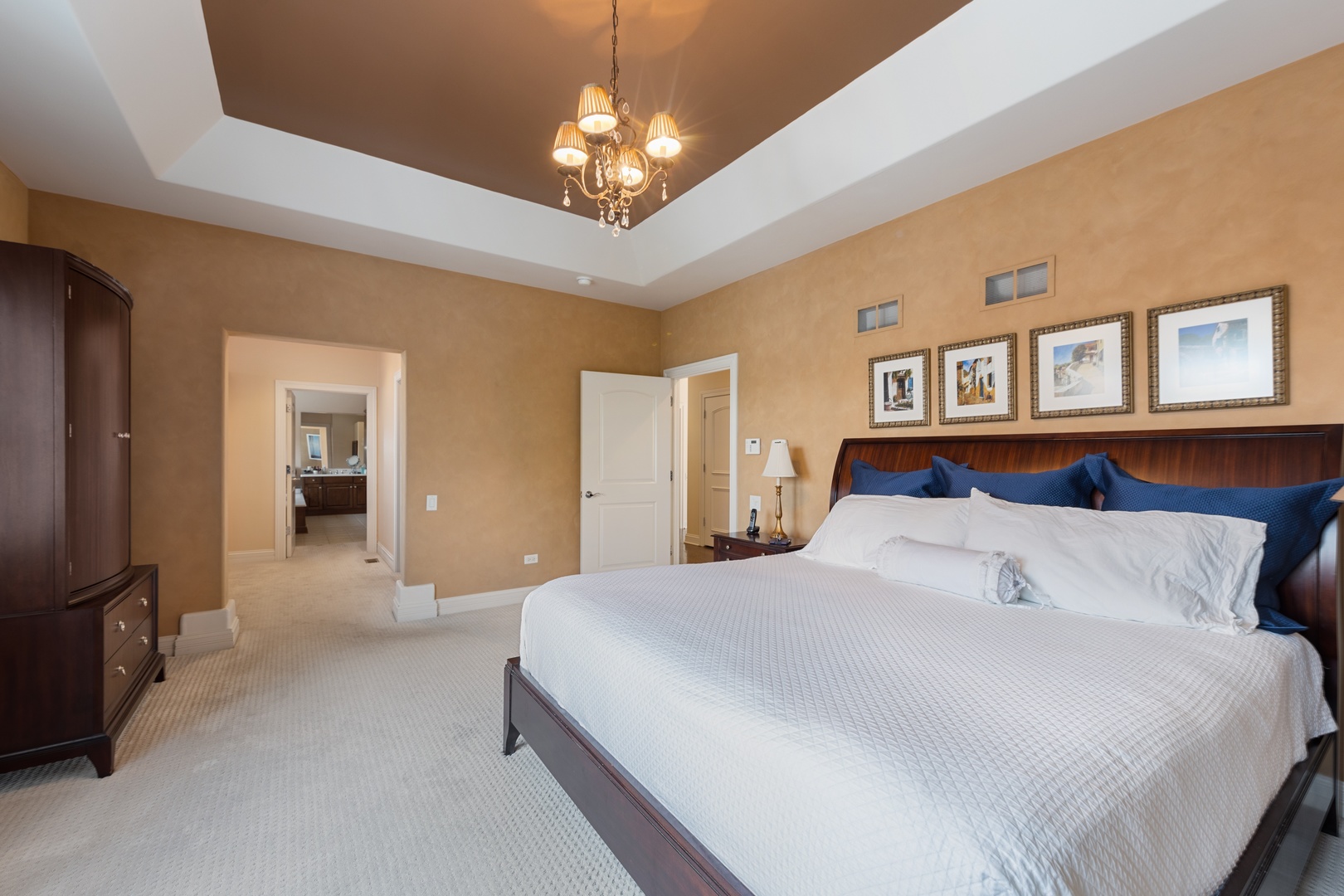 46 Willowcrest Drive Oak Brook, IL 60523 - Photo 16 of 25 a bedroom with a large bed and a chandelier