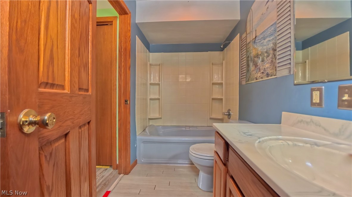 48276 Dyke Road Negley, OH 44441 - Photo 15 of 30 Bathroom featuring vanity, tub / shower combination, and light wood finished floors