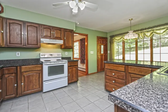 a kitchen with stainless steel appliances a stove sink and cabinets