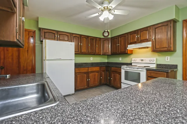 a kitchen with a sink appliances and cabinets