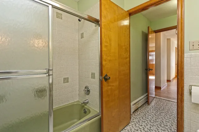 a bathroom with a shower and a sink