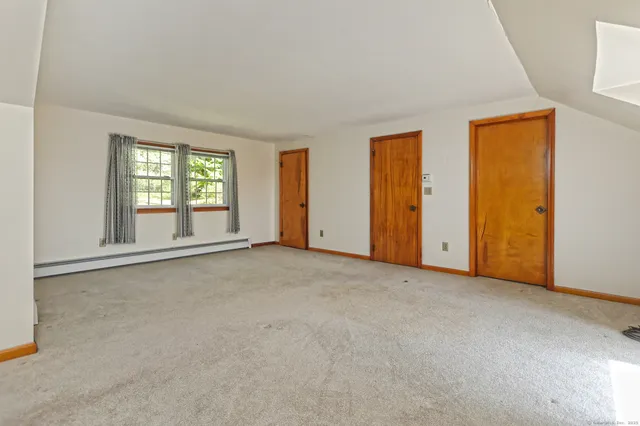 an empty room with windows and closet