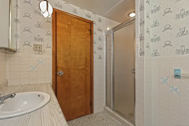 a bathroom with a tub and shower