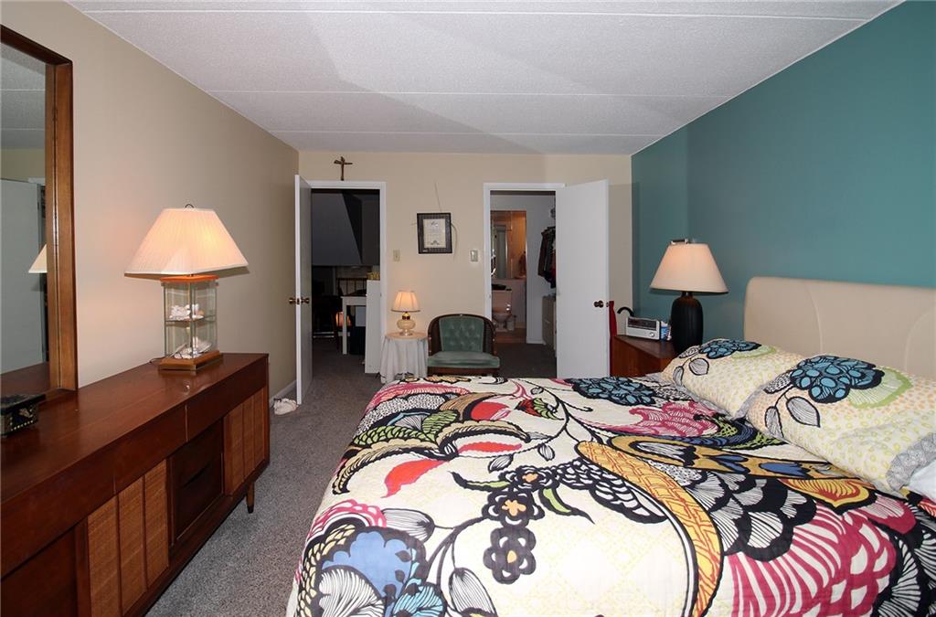 1160 Bower Hill Road, Unit 310A Pittsburgh, PA 15243 - Photo 16 of 46 a bedroom with a bed and a lamp