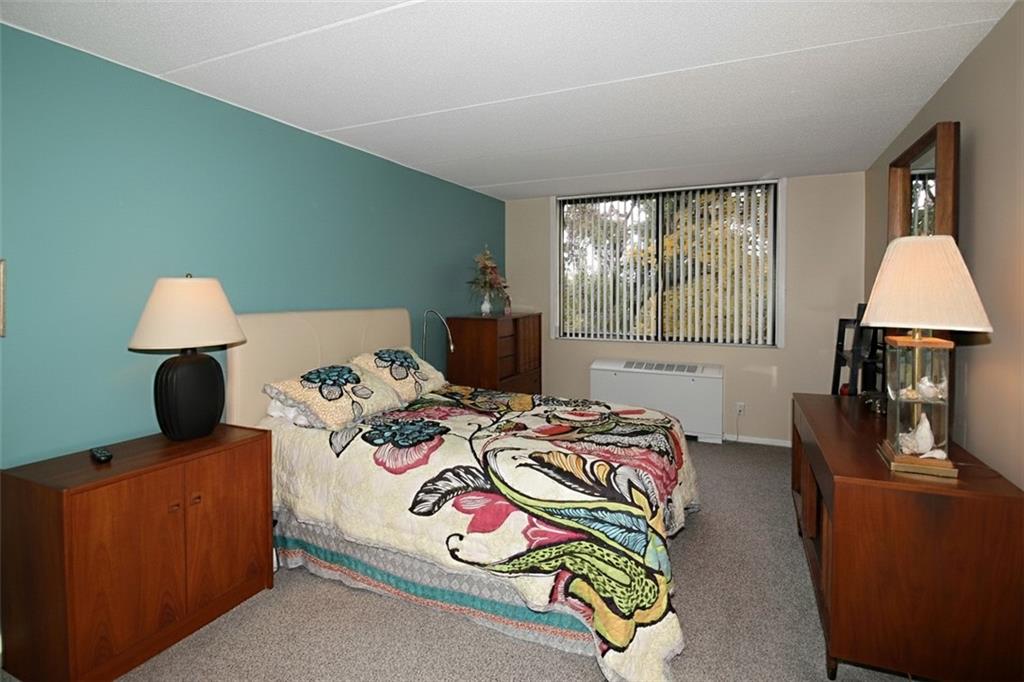 1160 Bower Hill Road, Unit 310A Pittsburgh, PA 15243 - Photo 17 of 46 a bed room with a bed and a chair