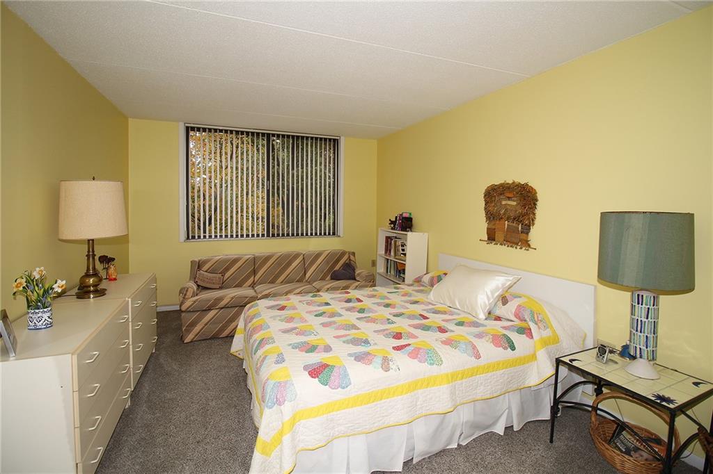 1160 Bower Hill Road, Unit 310A Pittsburgh, PA 15243 - Photo 23 of 46 a bedroom with a bed and a lamp on dresser