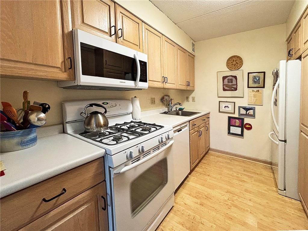1160 Bower Hill Road, Unit 310A Pittsburgh, PA 15243 - Photo 3 of 46 a kitchen with stainless steel appliances a stove a microwave and cabinets