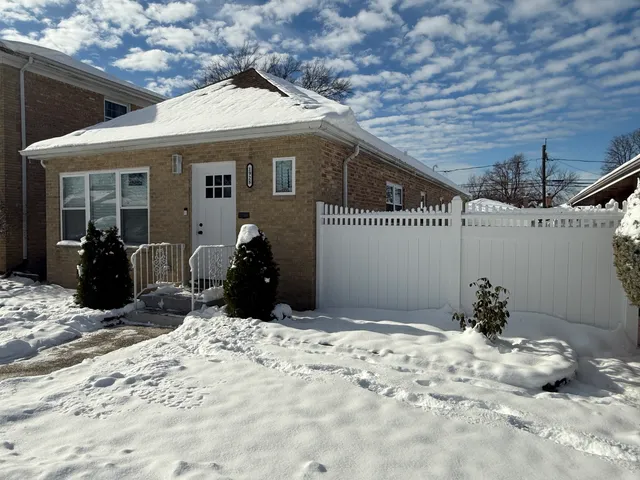 a view of a house with a snow in the backyard