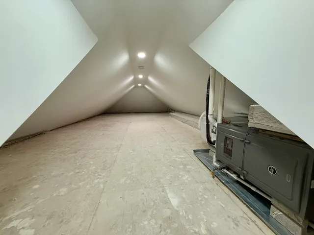 an empty room with wooden floor and entrance