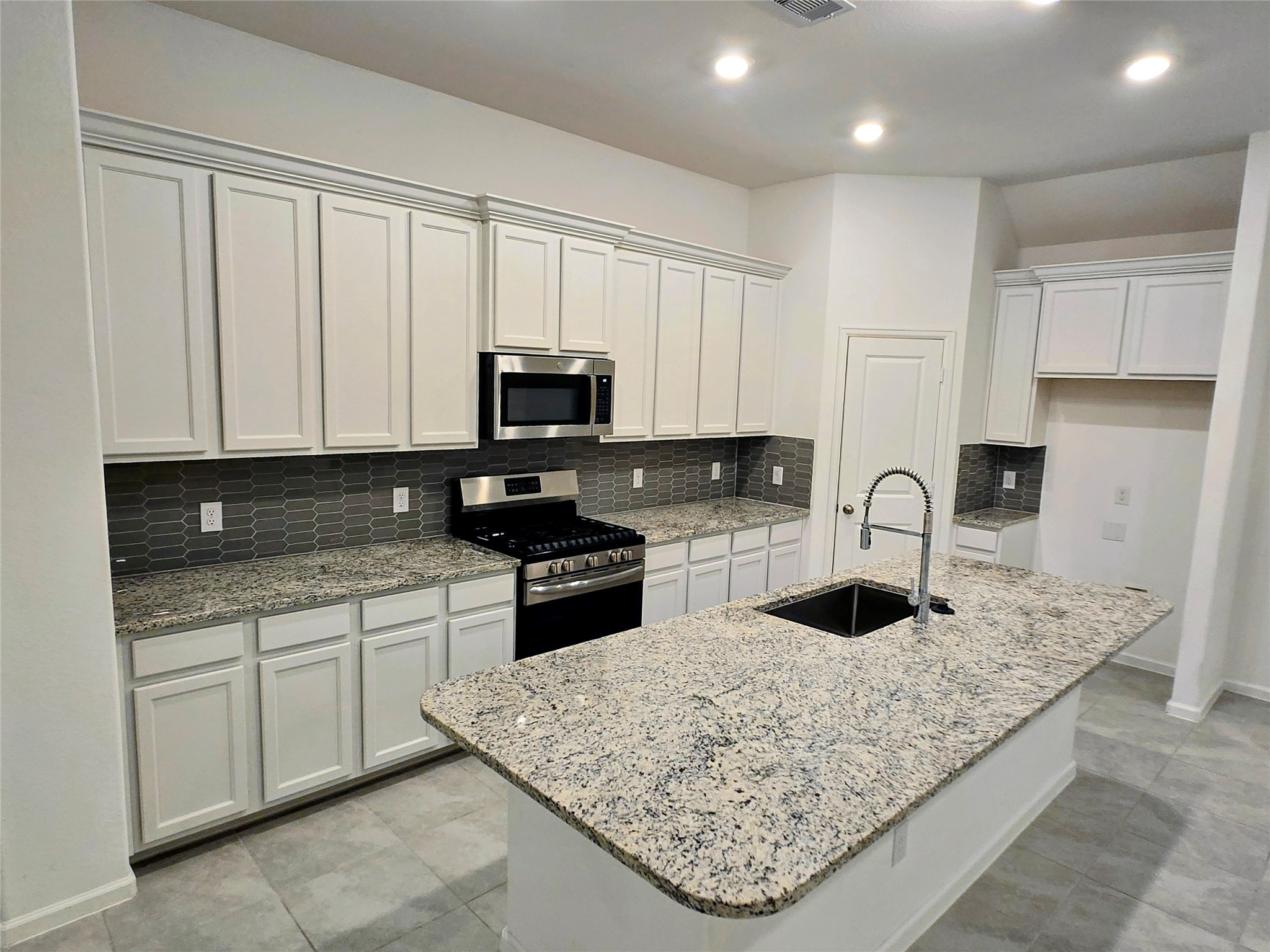 3632 Richmont Court Rosenberg, TX 77469 - Photo 6 of 23 a kitchen with stainless steel appliances granite countertop a sink stove and refrigerator