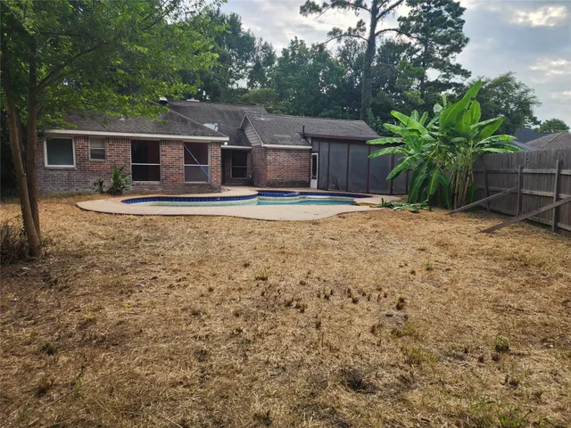 a backyard of a house with table and chairs
