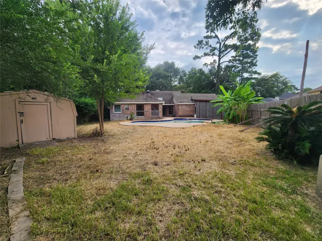 a view of a house with backyard and sitting area