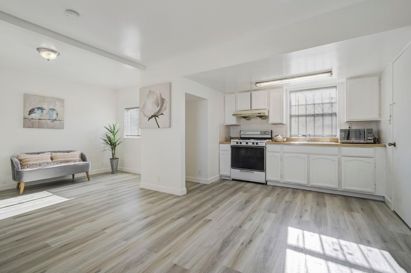 3618 MacArthur Boulevard Oakland, CA 94619 - Photo 37 of 65 a kitchen with granite countertop a refrigerator and a stove top oven