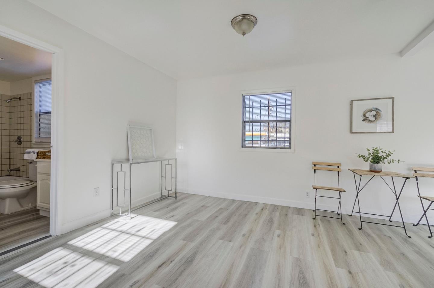 3618 MacArthur Boulevard Oakland, CA 94619 - Photo 39 of 65 a view of a room with wooden floor and windows