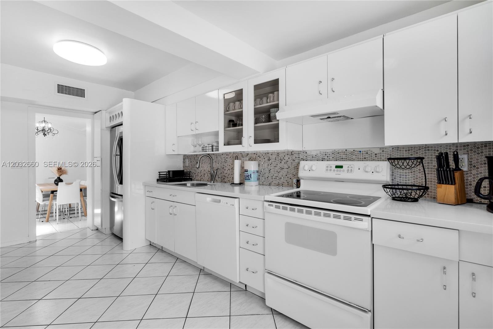 520 Southwest 22nd Road Miami, FL 33129 - Photo 40 of 76 a kitchen with white cabinets and white appliances