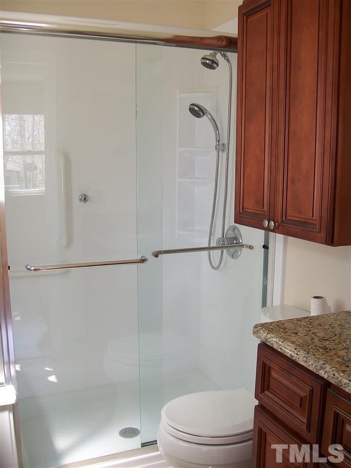 7704 Prospector Place Raleigh, NC 27615 - Photo 8 of 14 Recently updated master bath with granite counter, tile floor, new shower