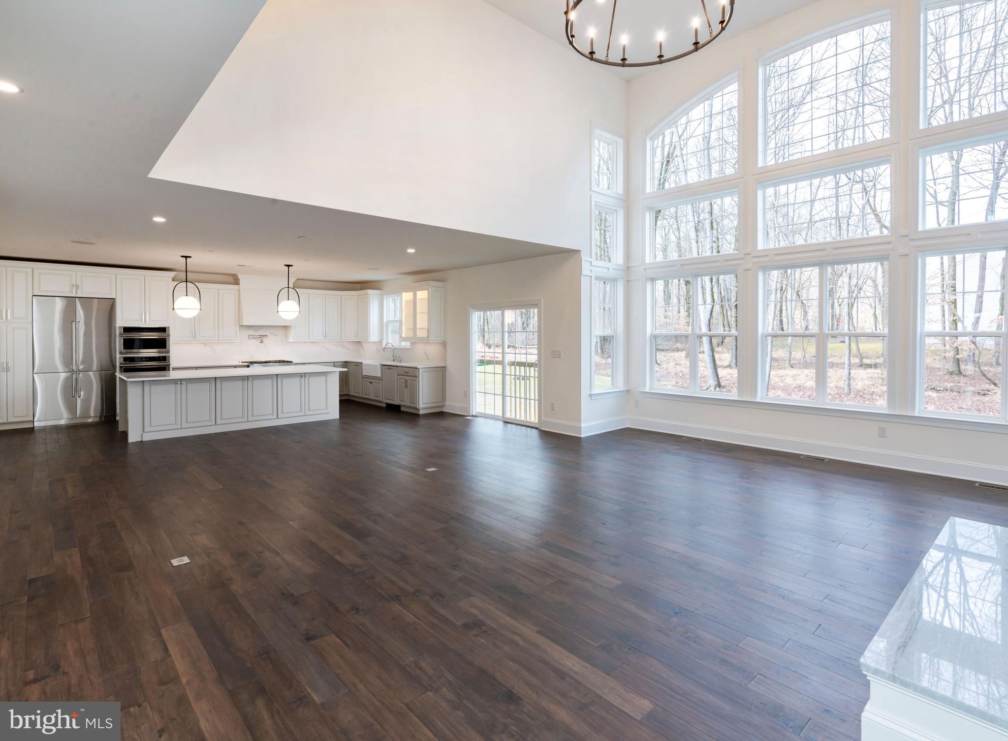190 Plymouth Road Blue Bell, PA 19422 - Photo 14 of 27 a view of an empty room with a window and wooden floor