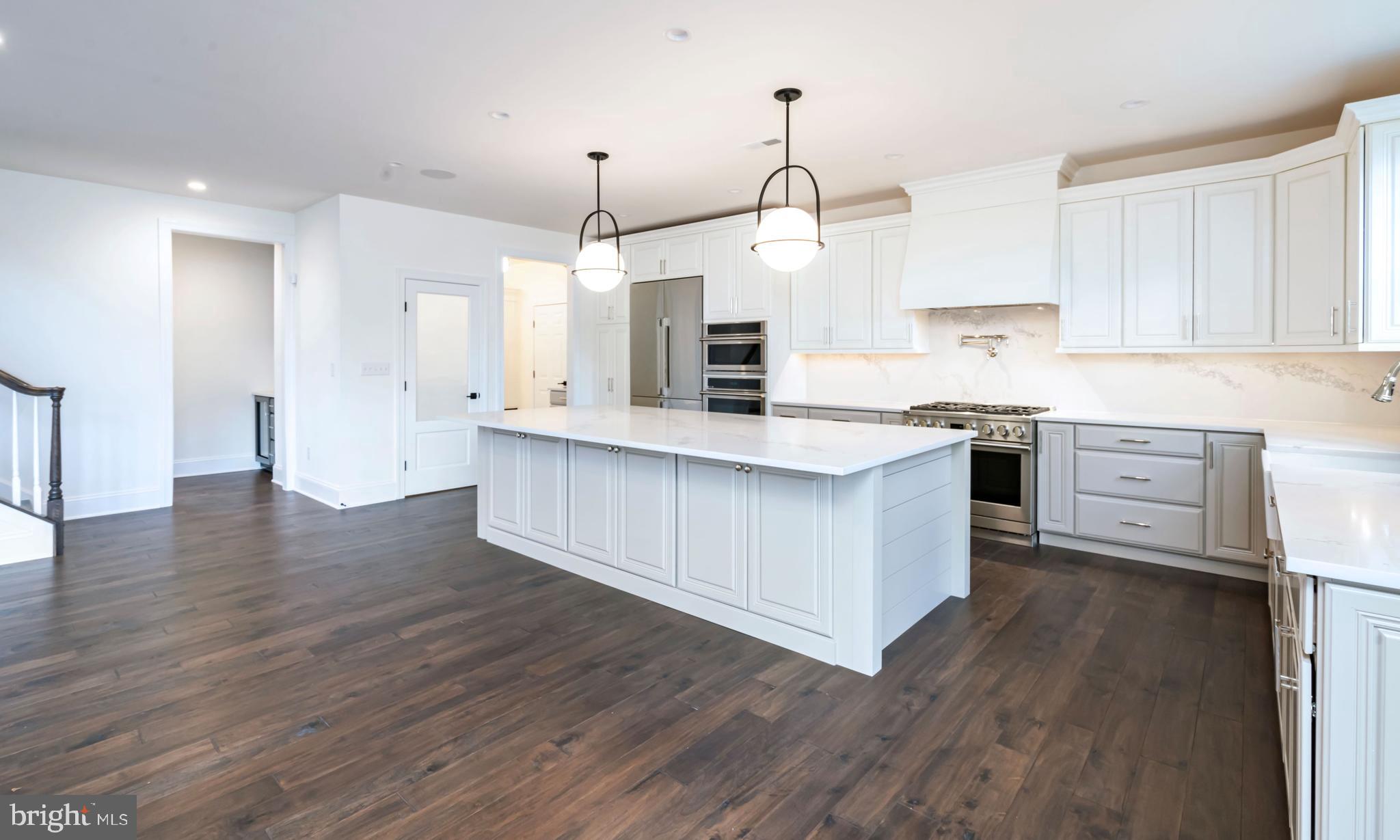190 Plymouth Road Blue Bell, PA 19422 - Photo 20 of 27 a kitchen with stainless steel appliances granite countertop a sink a stove and a wooden floors