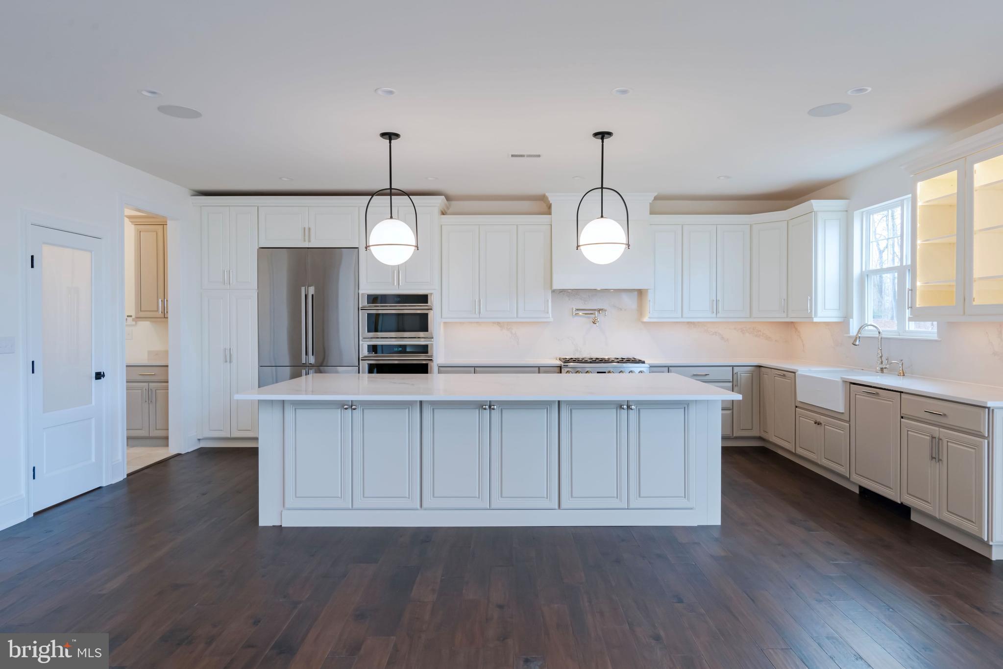 190 Plymouth Road Blue Bell, PA 19422 - Photo 21 of 27 a kitchen with kitchen island granite countertop a stove a sink a center island and a window