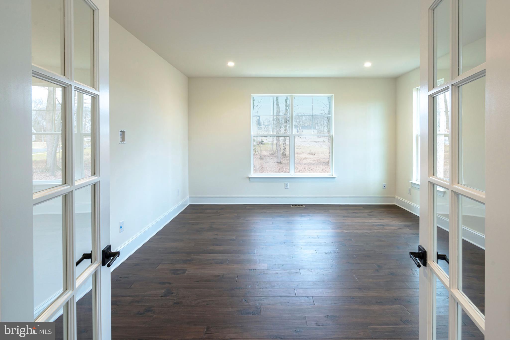 190 Plymouth Road Blue Bell, PA 19422 - Photo 22 of 27 a view of an empty room with wooden floor and a window