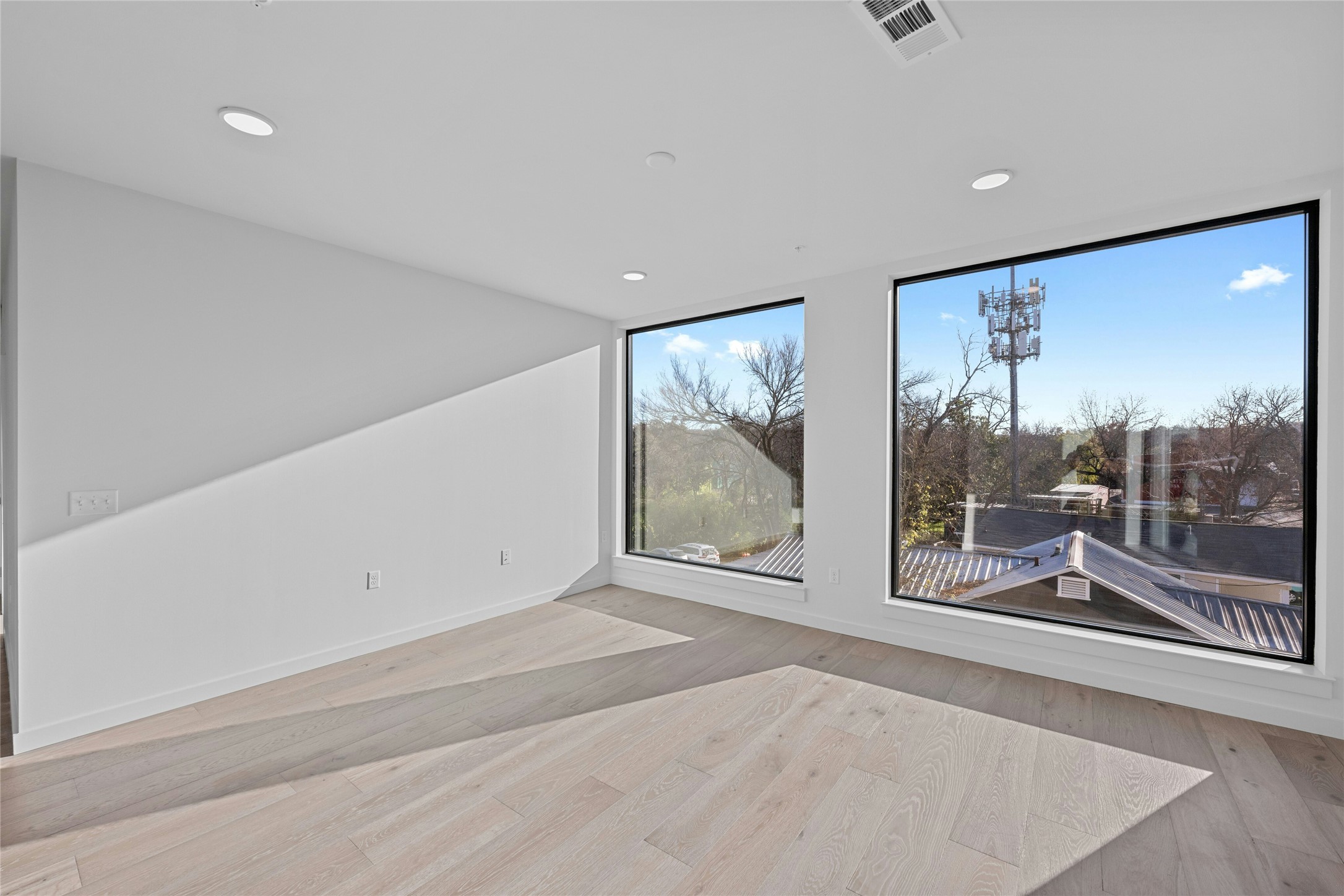 2209 South 1st Street, Unit 321 Austin, TX 78704 - Photo 12 of 40 Empty room with light wood-style flooring and recessed lighting