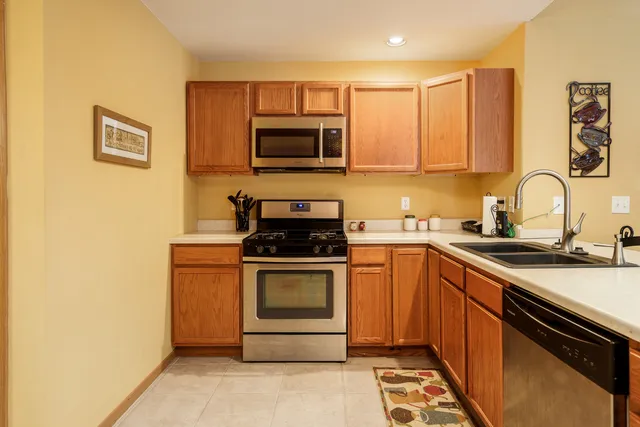 a kitchen with stainless steel appliances granite countertop a stove and a sink