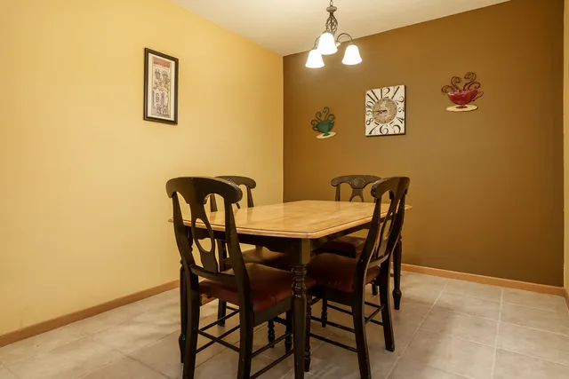 a view of a dining room with furniture and chandelier