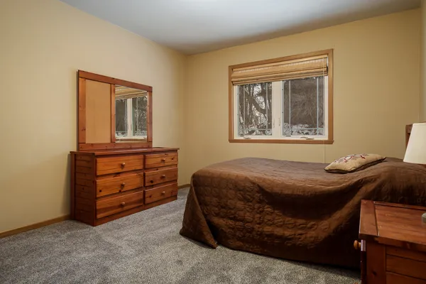 a bedroom with a bed and a dresser