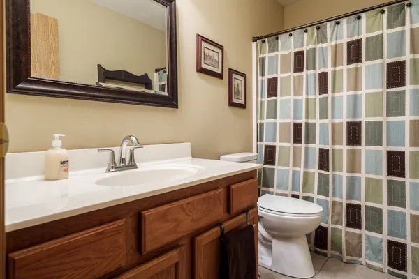 a bathroom with a sink a toilet and a mirror