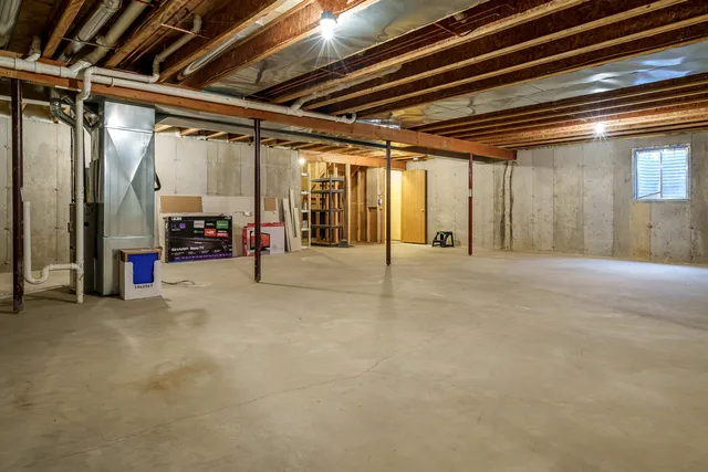a view of water heater room with stairs