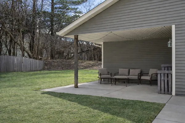 a view of a house with backyard and a garden