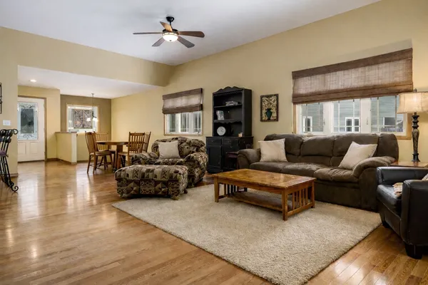 a living room with furniture and a chandelier