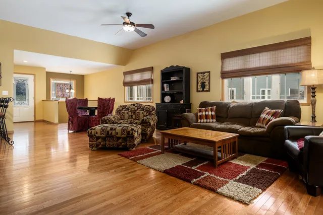 a living room with furniture rug and wooden floor
