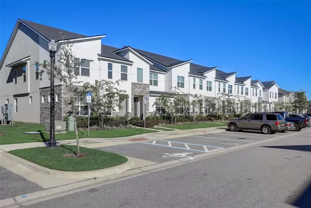 a car parked in front of a white house