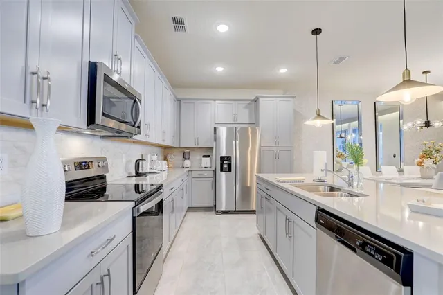 a bedroom with a bed dresser and window