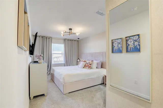 a bedroom with a bed and window