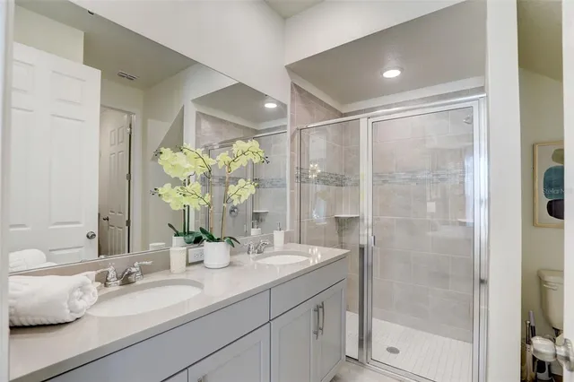 a bathroom with a sink vanity mirror and toilet