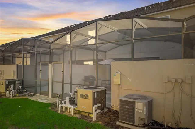 a backyard of a house with table and chairs