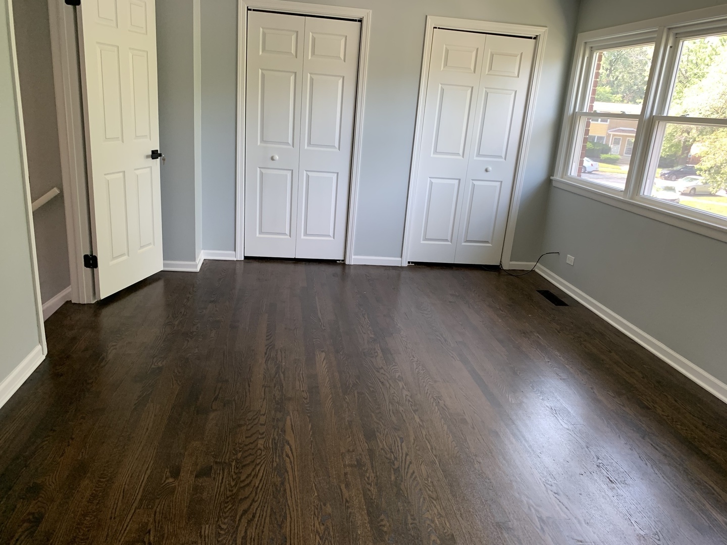 74 West 140th Street Riverdale, IL 60827 - Photo 10 of 20 an empty room with wooden floor and windows