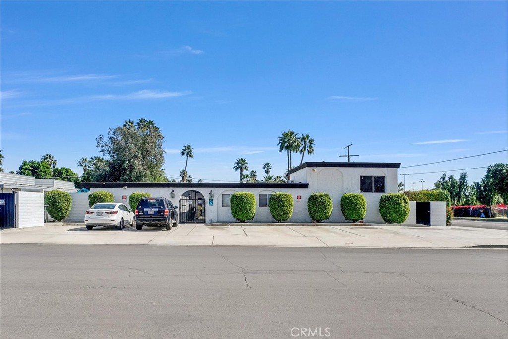 1900 East Baristo Road Palm Springs, CA 92262 - Photo 2 of 23 a front view of a house with a yard and garage